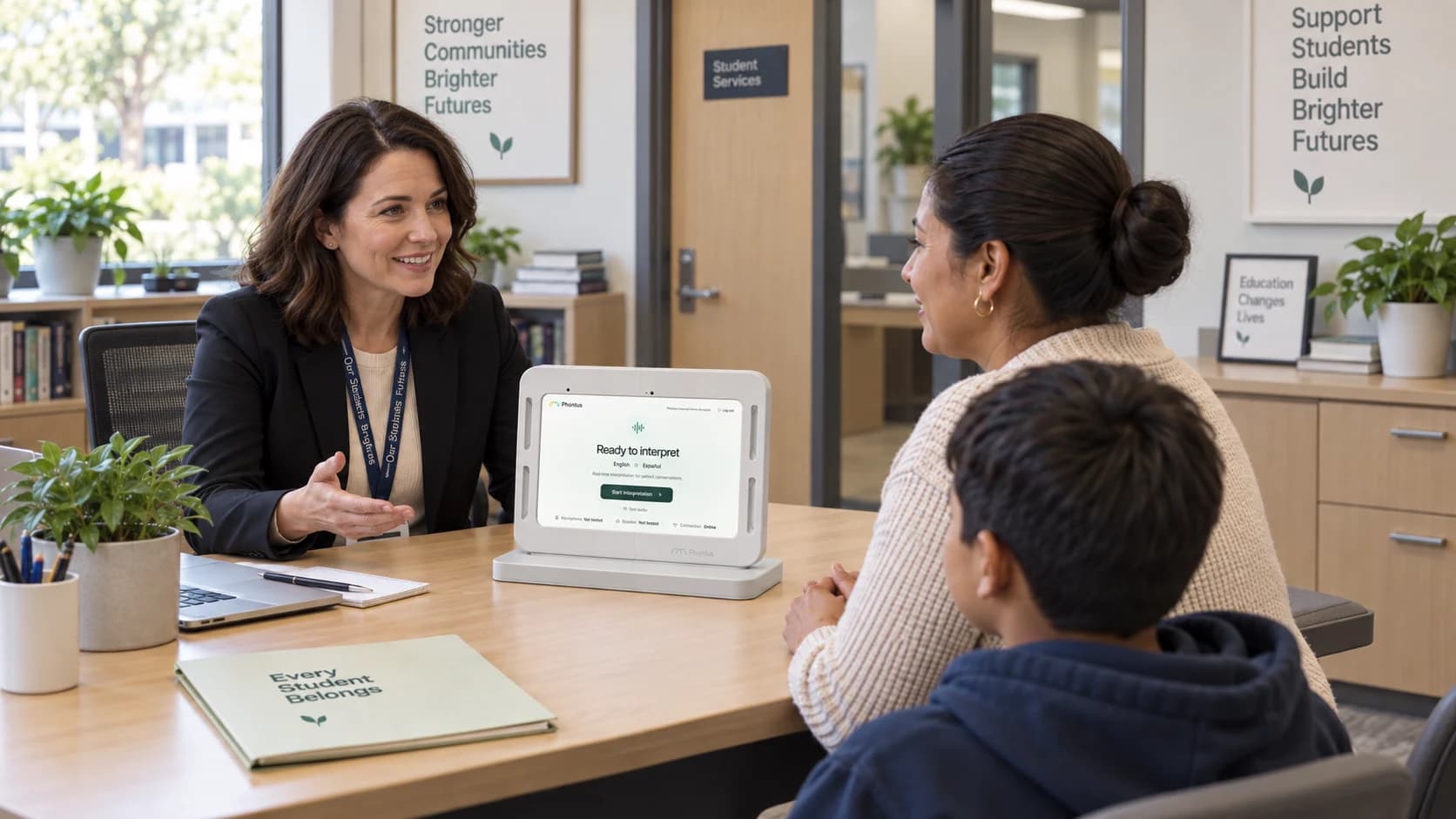 A school staff member meeting with a parent and child around a Phontus Interpreting Kit.